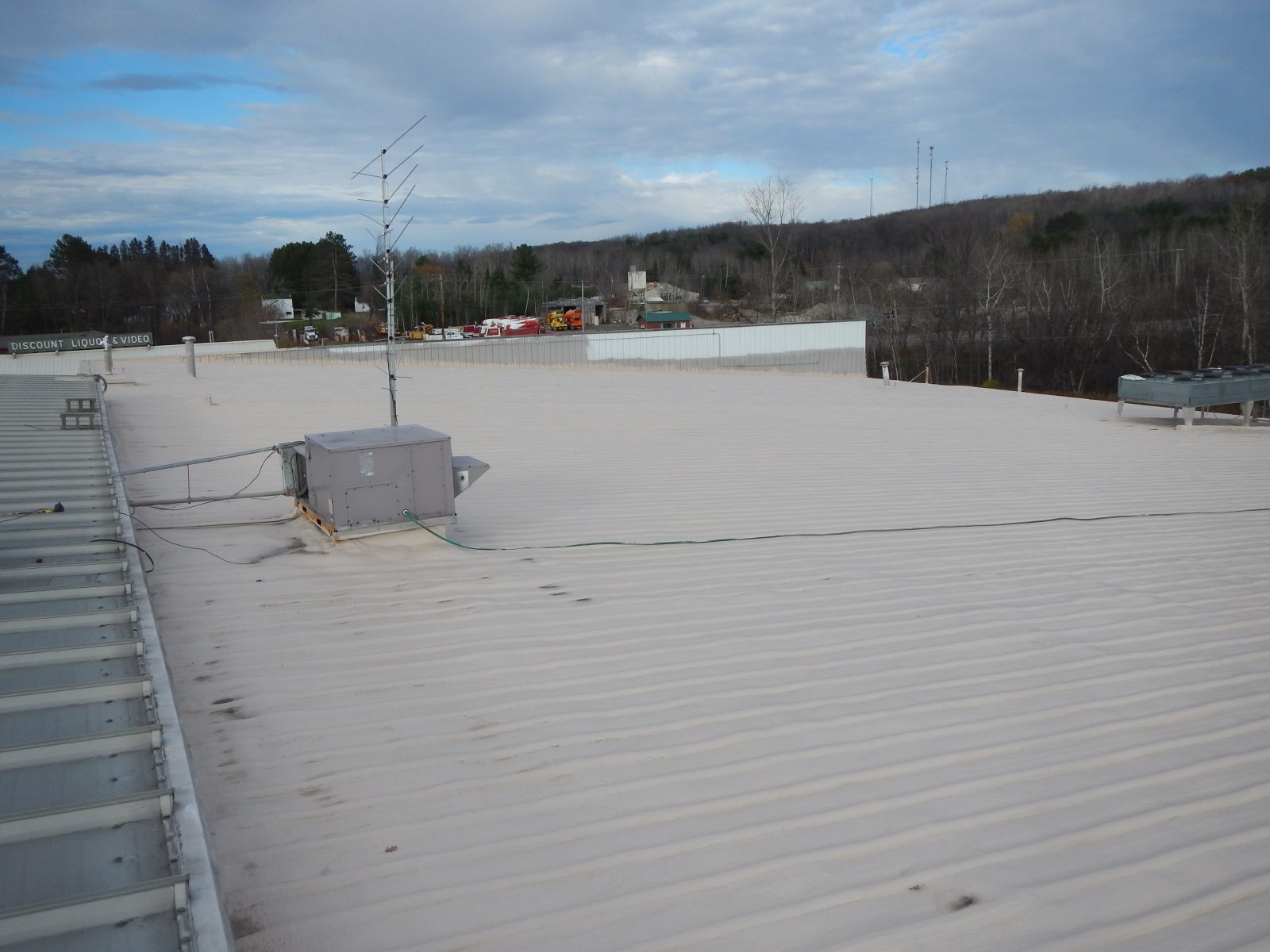 Standing seam metal roof restored with polyurea coating