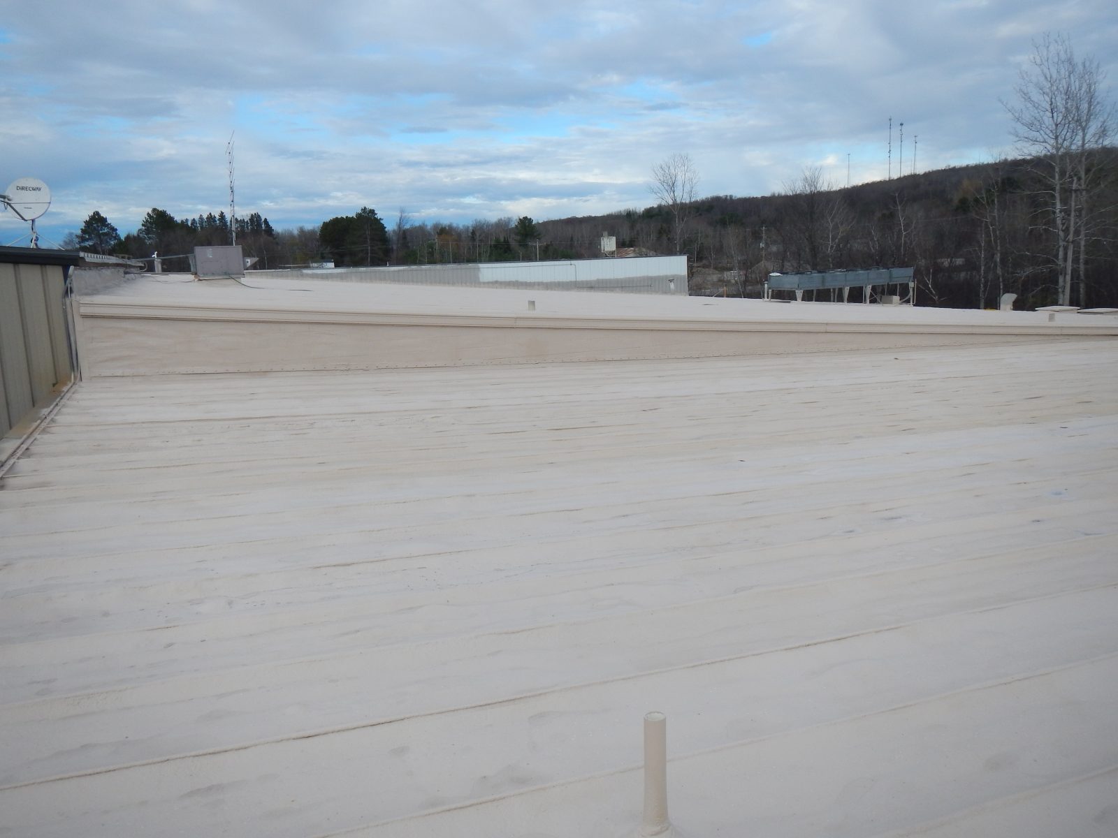 Roof penetration and curb detail sealed with polyurea coating