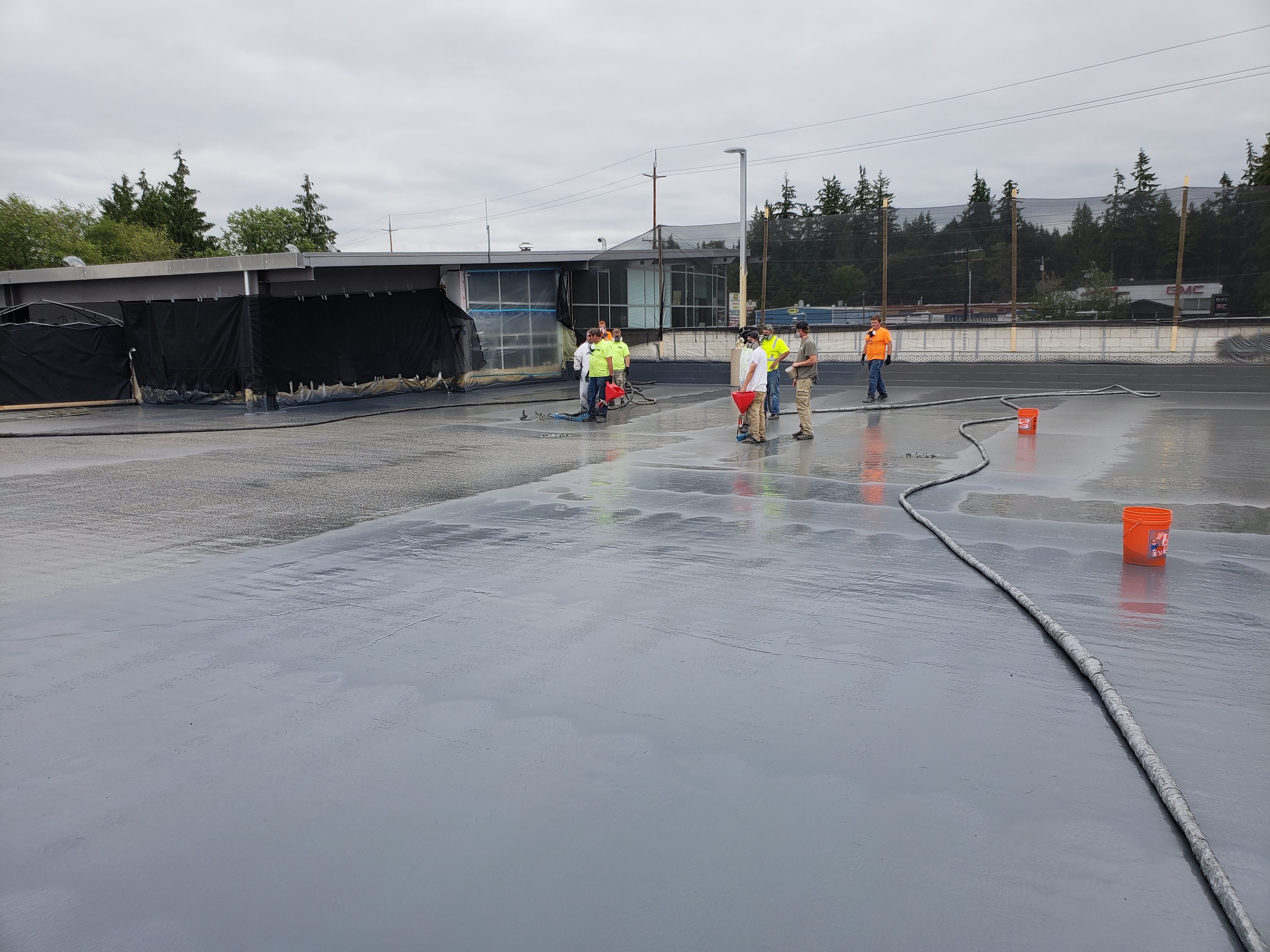 Commercial metal roof coated with seamless polyurea membrane